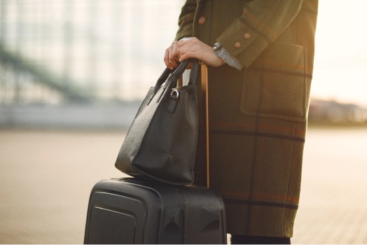 Woman with suitcase standing by airport