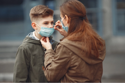 Boy and mother are wearing protective masks