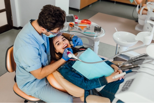 Young female patient with open mouth examining dental inspection dentist office