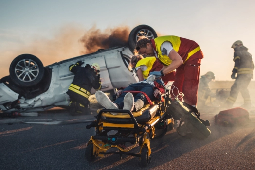 Paramedics and firefighters assisting at an accident site.