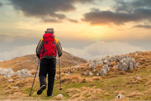 Hiker watching sunset from mountain