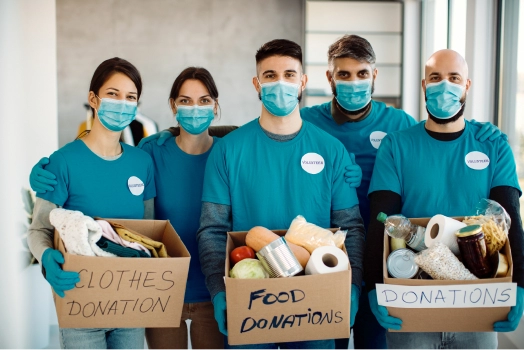 Team of volunteers holding donation boxes