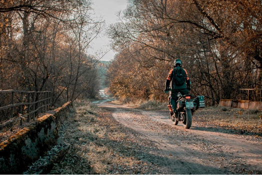 Man biking down a dirt road.